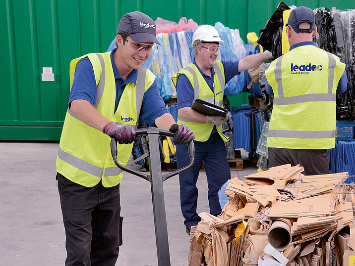 A Leadec employee with a pallet of paper waste at a waste yard.